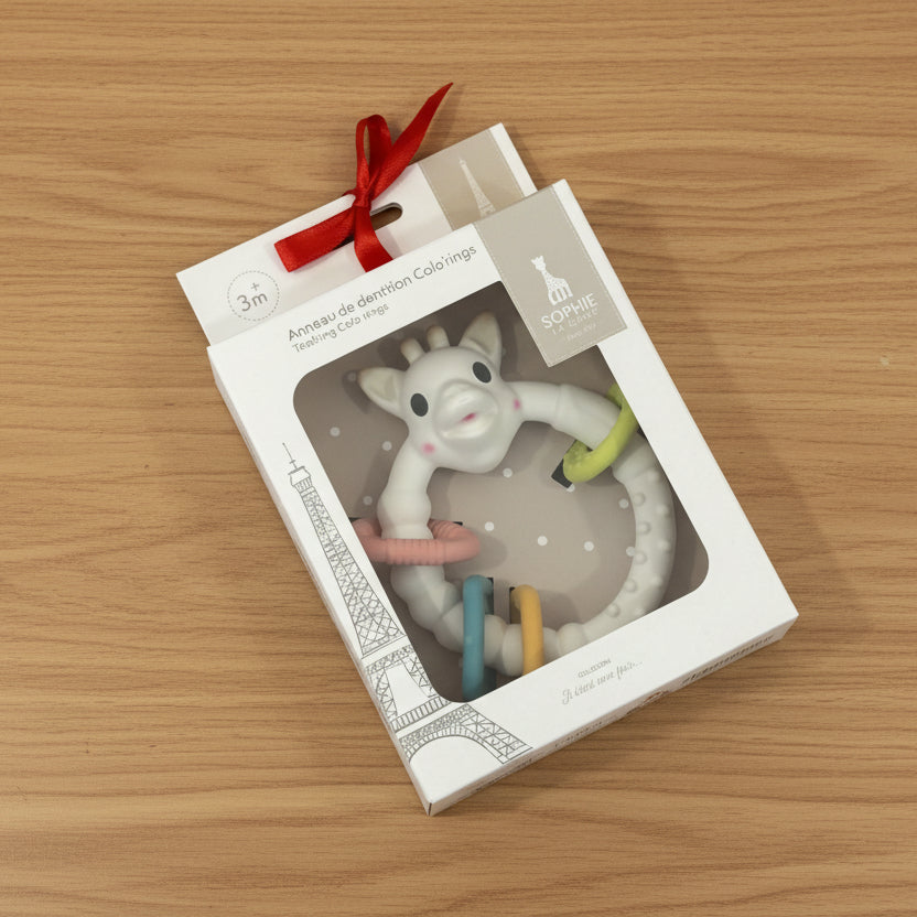 Teething toy in packaging on a festive patterned background