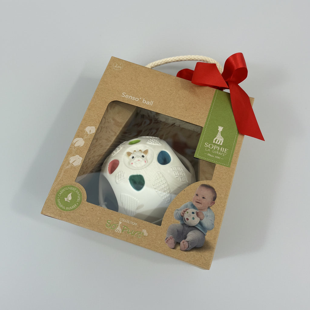 Baby sensor ball in a brown box with a red ribbon on a grey background